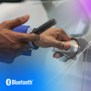Stylishly unlocking a car door with a smartphone, showcasing modern technology and convenience.